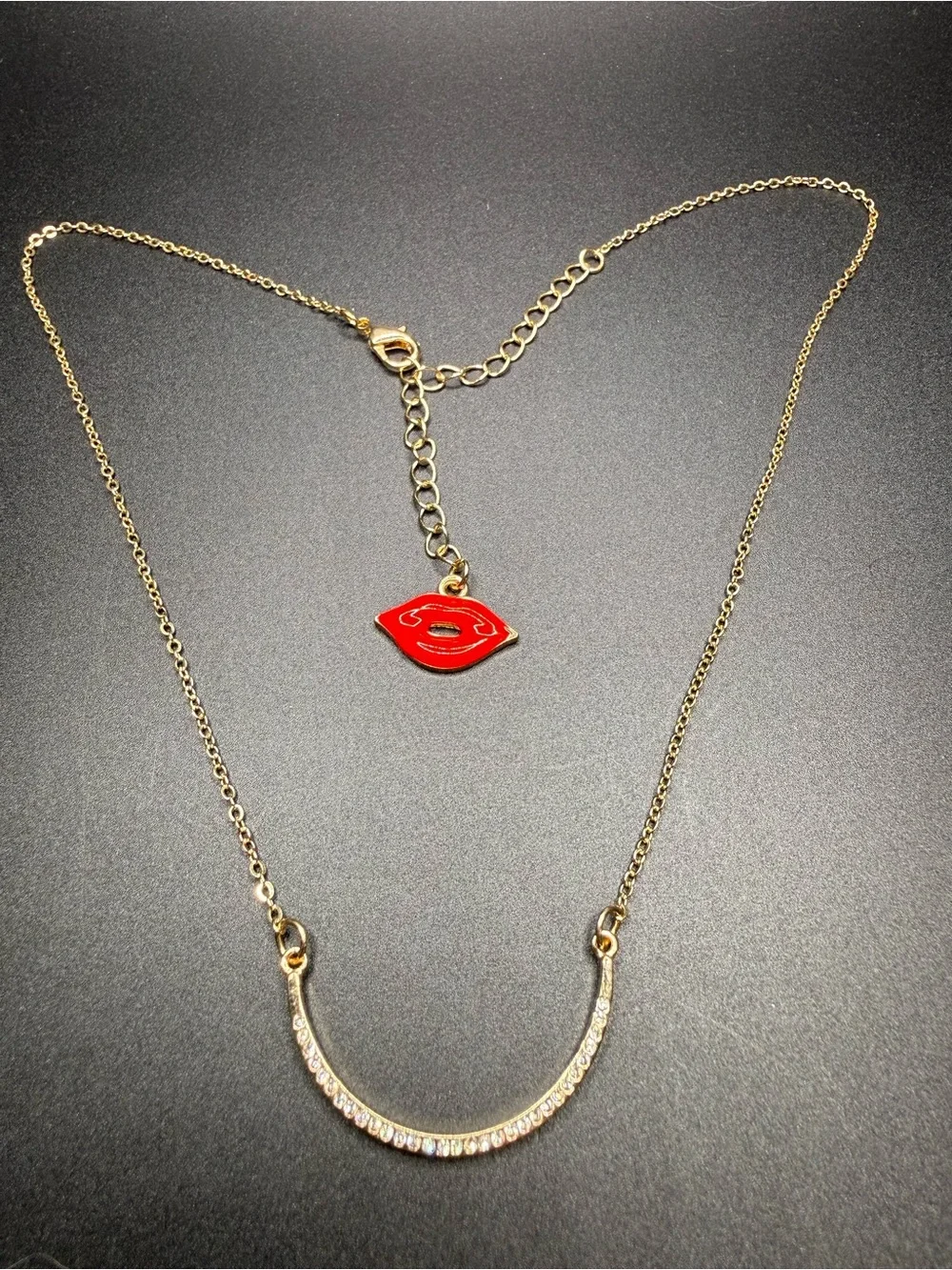 Gold-Tone Crystal Curved Bar Necklace with Red Lip Charm